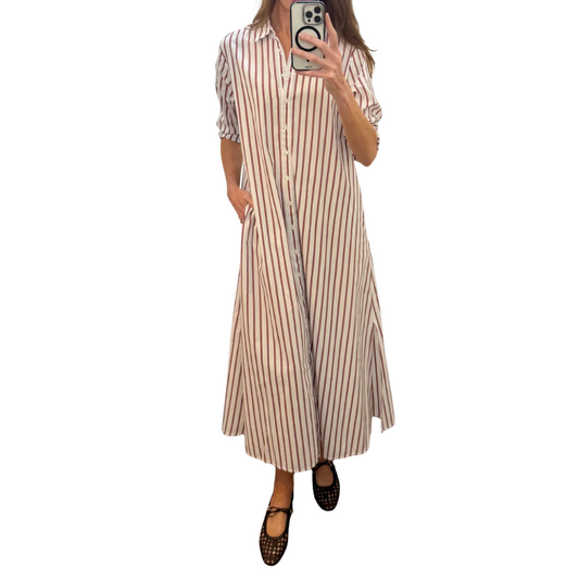 Woman wearing a long striped dress on a white background