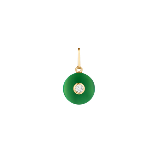 Green pendant with gold frame and clear gemstone on a white background