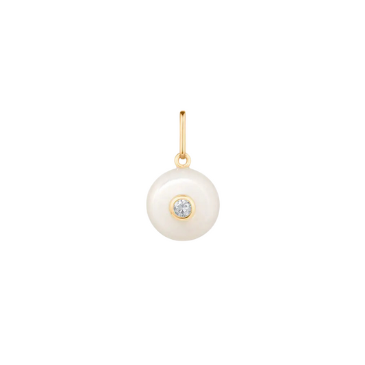 Pearl pendant with gold hook and gemstone on a white background