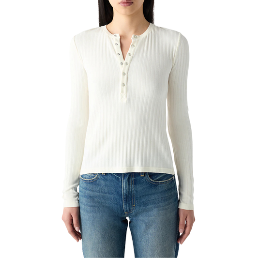 White ribbed long-sleeve top worn by a person on a white background