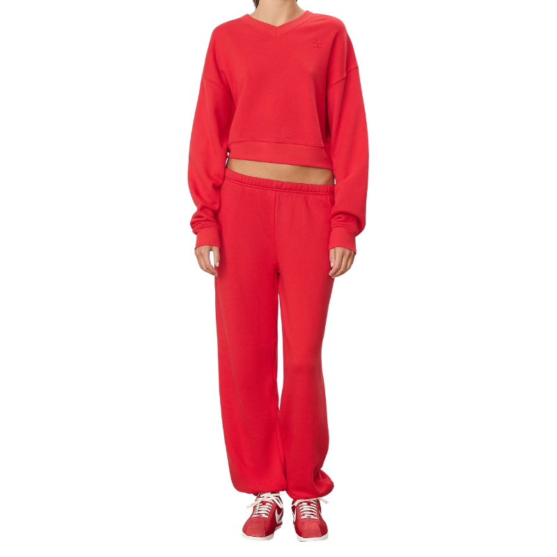 Red sweatshirt and pants set worn by a person on a white background