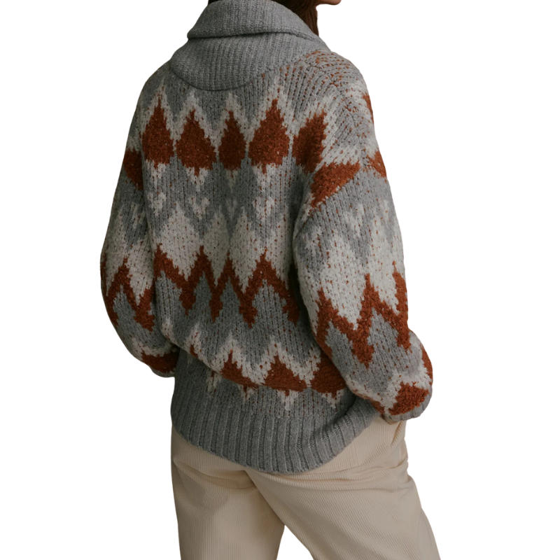 Person wearing a patterned sweater with a white background