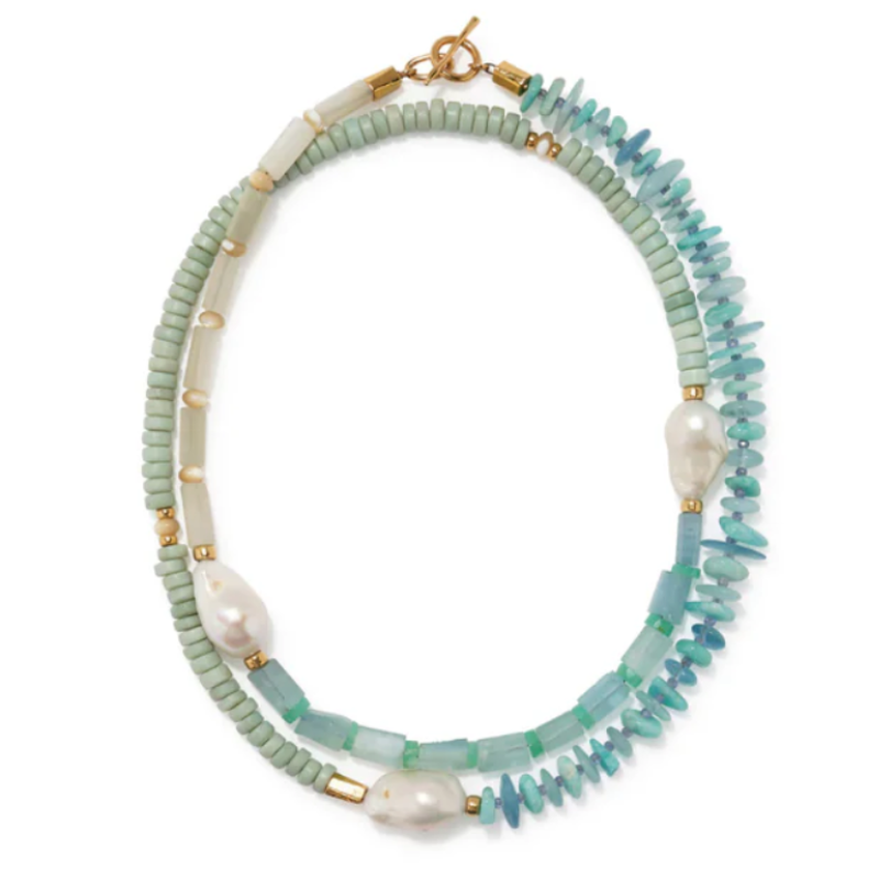 Necklace with green beads and gold accents on a white background