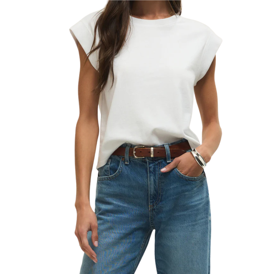 Person wearing a white sleeveless top and blue jeans on a white background