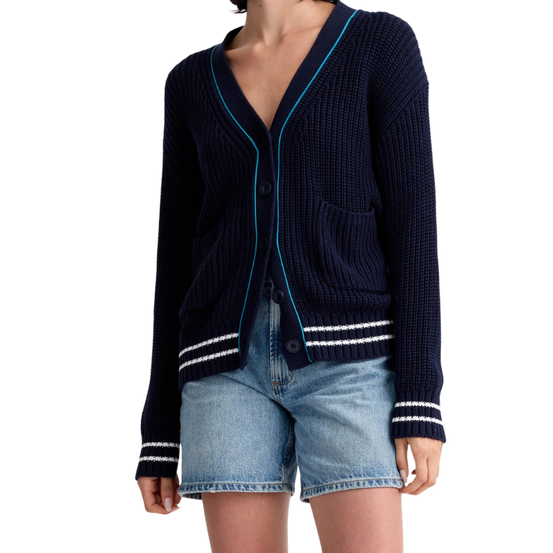 Navy cardigan with white trim worn over denim shorts on a white background