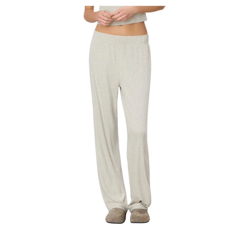 Person wearing light gray lounge pants on a white background