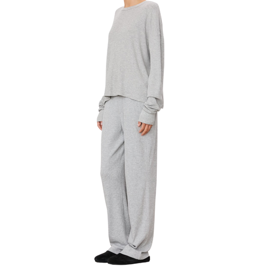 Person wearing a gray outfit on a white background