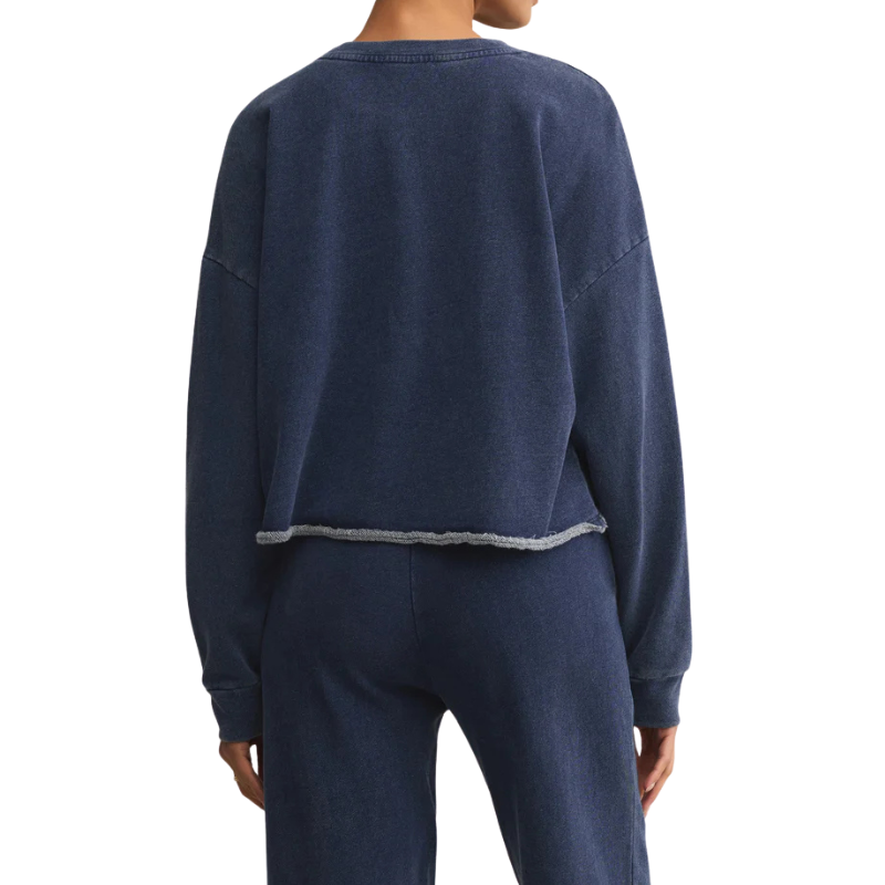 Person wearing a navy blue sweatshirt and pants on a white background