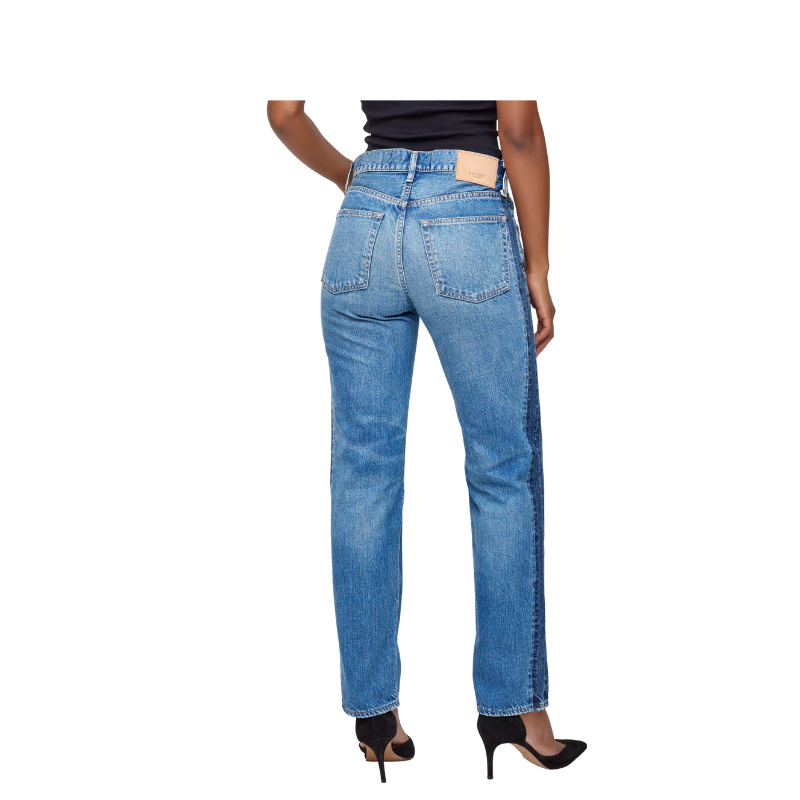 Blue jeans worn by a person on a white background