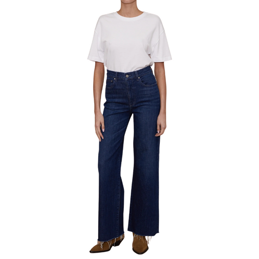 Person wearing a white t-shirt and blue jeans on a white background