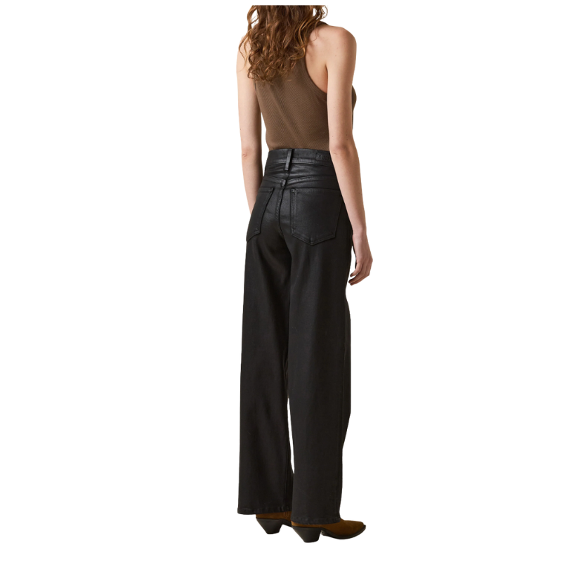 Person wearing high-waisted black pants on a white background