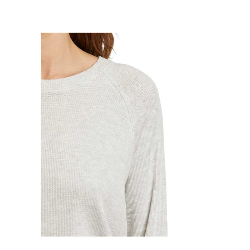 Light gray sweater worn by a person on a white background