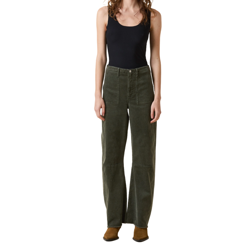 Person wearing green pants and a black tank top on a white background