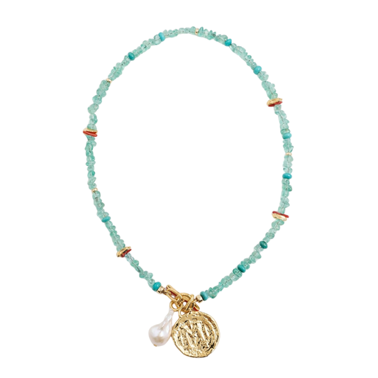 Necklace with turquoise beads and a gold charm on a white background