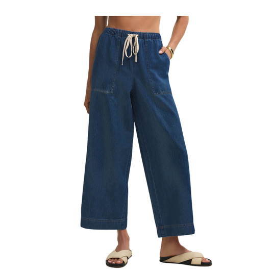 Blue wide-leg pants worn by a person on a white background