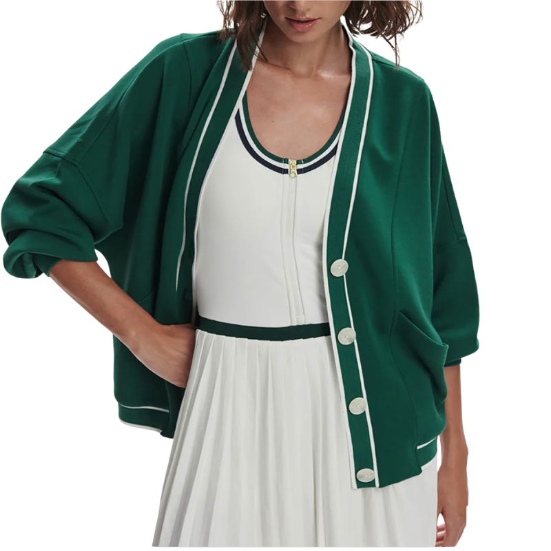 Green cardigan over a white dress on a plain background