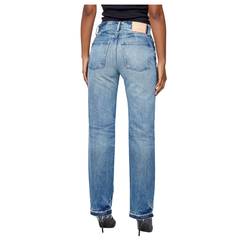 Blue jeans worn by a person on a white background