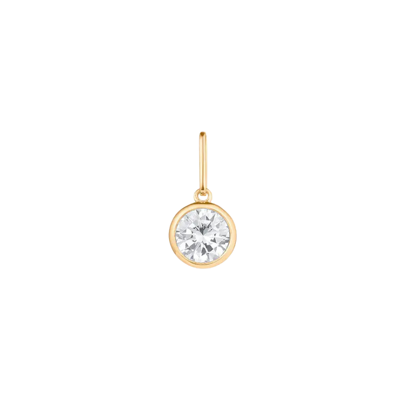 Gold earring with a clear gemstone on a white background