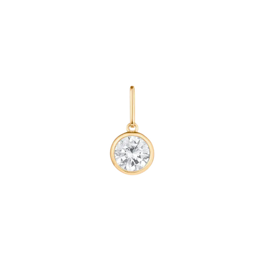 Gold earring with a clear gemstone on a white background