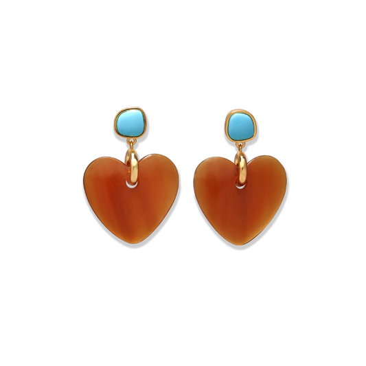 Heart-shaped earrings with turquoise stones on a white background
