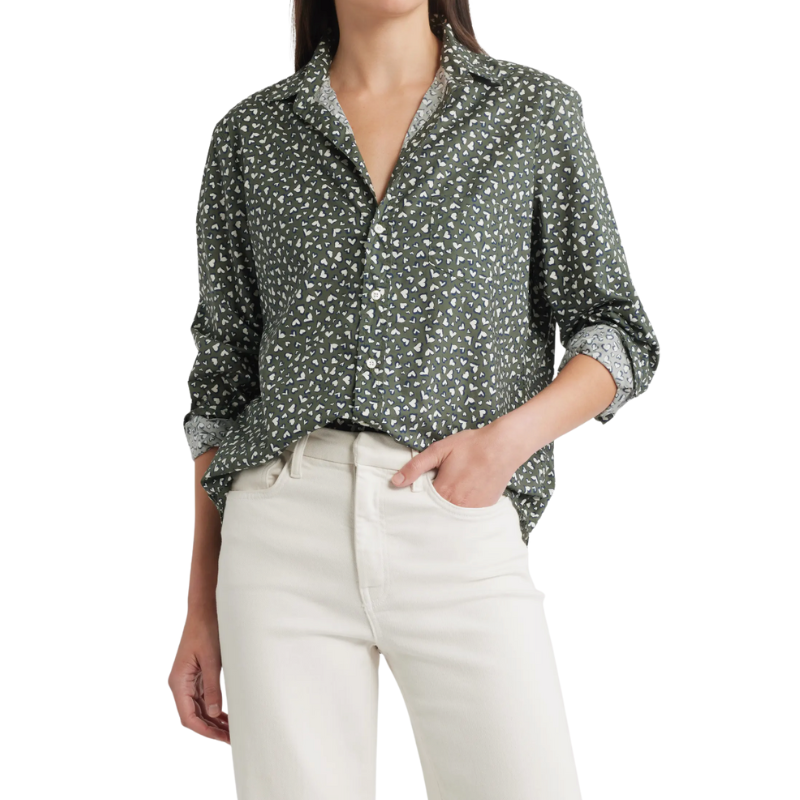 Person wearing a patterned shirt and white pants on a white background