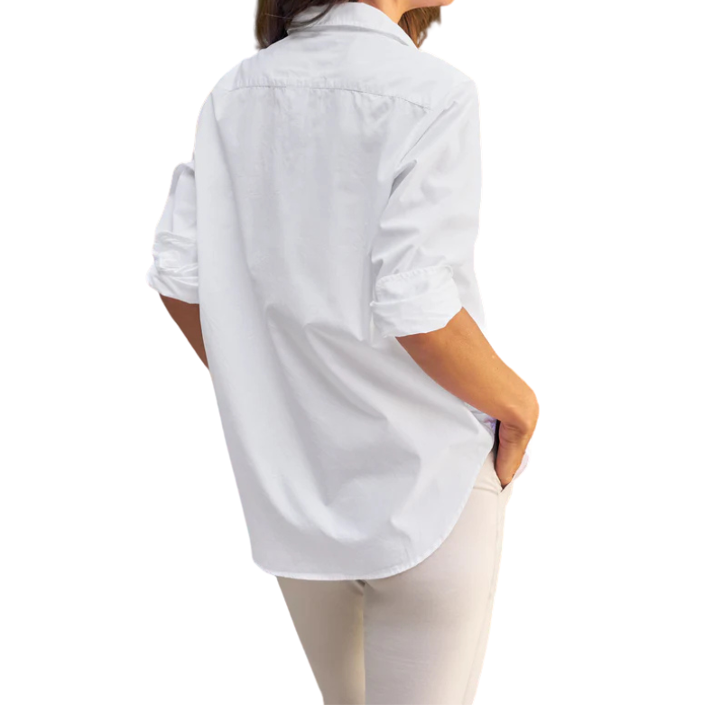 Person wearing a white button-up shirt and beige pants on a white background