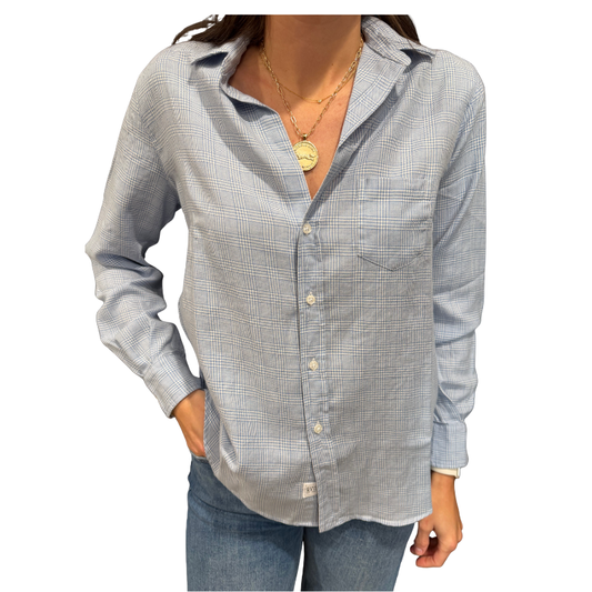 Person wearing a checkered shirt and jeans on a white background