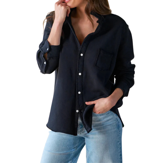 Woman wearing a black button-up shirt and blue jeans on a white background