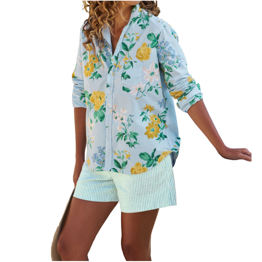 Woman wearing a floral shirt and shorts set on a white background
