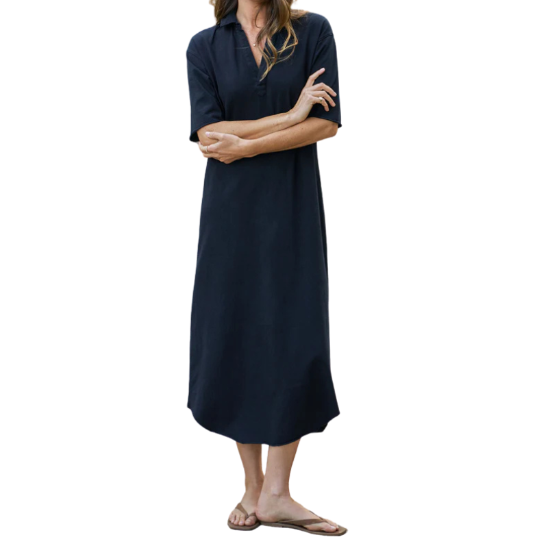 Woman wearing a navy blue dress on a white background