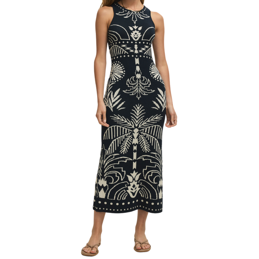 Woman wearing a black and white patterned sleeveless dress on a white background