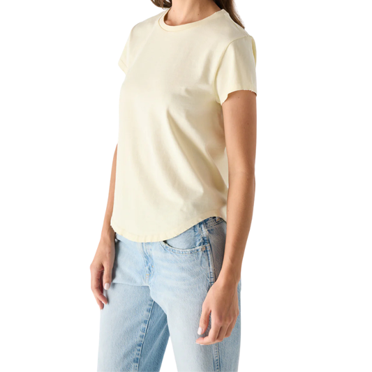 Person wearing a light yellow t-shirt and light blue jeans on a white background