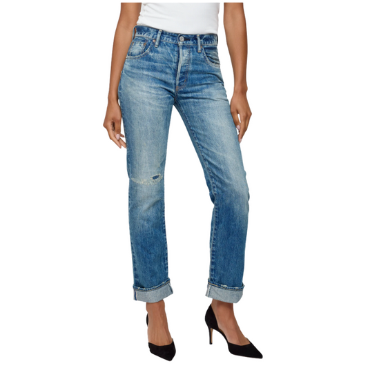 Blue jeans worn by a person on a white background