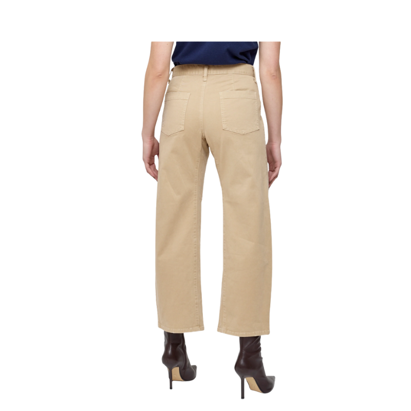 Beige pants worn by a person on a white background
