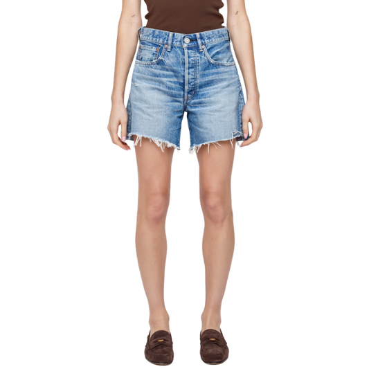 Person wearing blue denim shorts on a white background