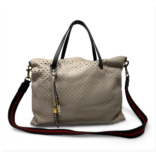 Beige textured handbag with black handles and a red and black strap on a white background