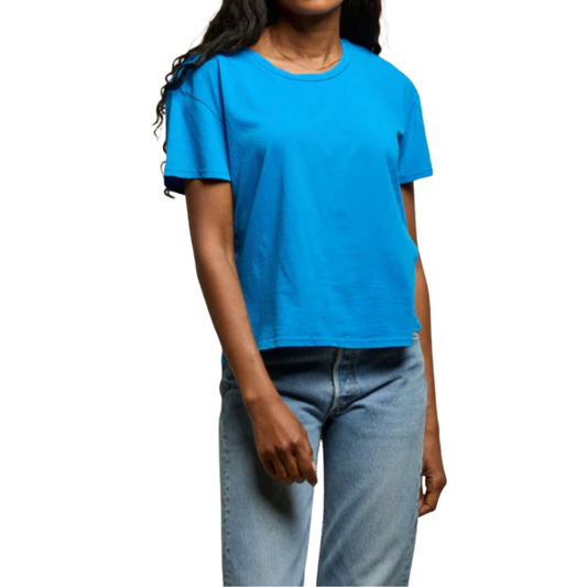 Person wearing a blue t-shirt and jeans on a white background