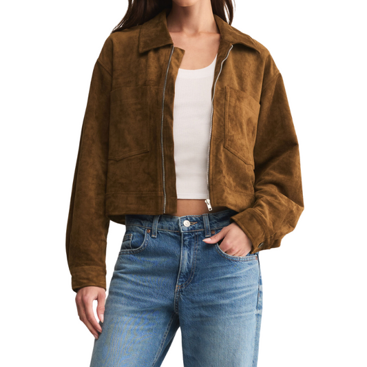 Person wearing a brown suede jacket and blue jeans on a white background