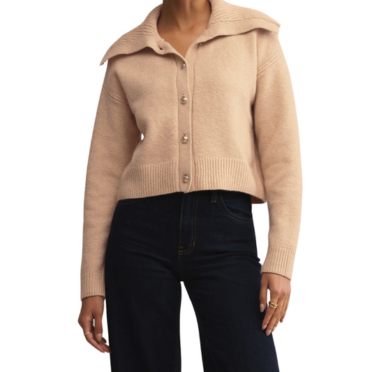 Beige knitted cardigan worn by a person on a white background