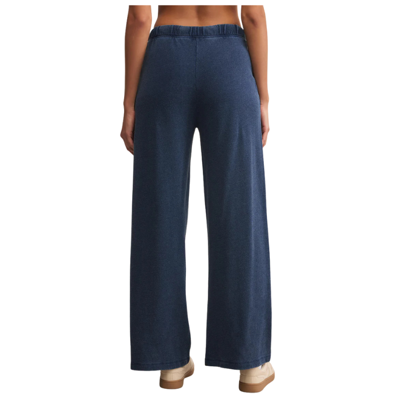 Navy blue wide-leg pants worn by a person on a white background