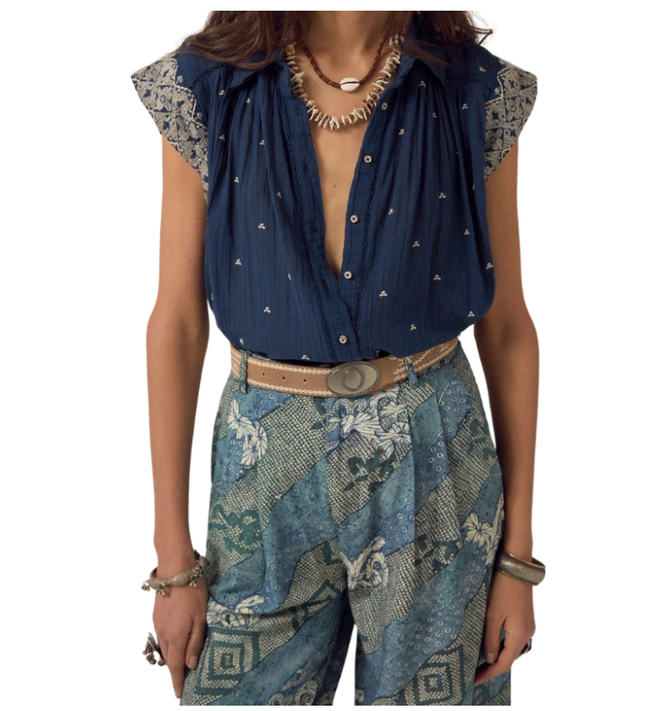 Person wearing a blue patterned top and pants on a white background