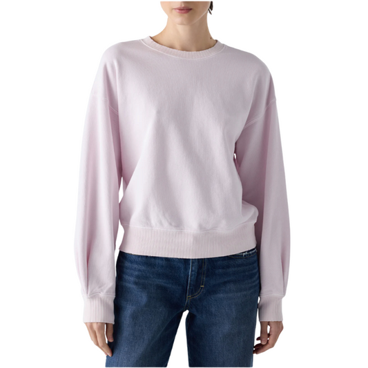 Light pink sweater worn by a person on a white background