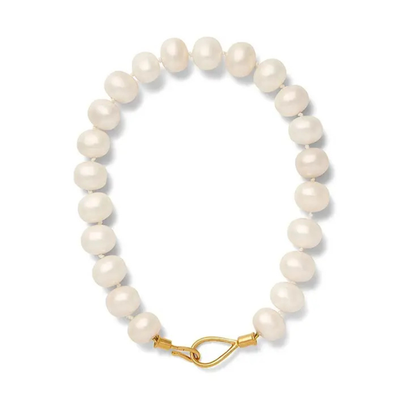 Pearl bracelet with a gold clasp on a white background
