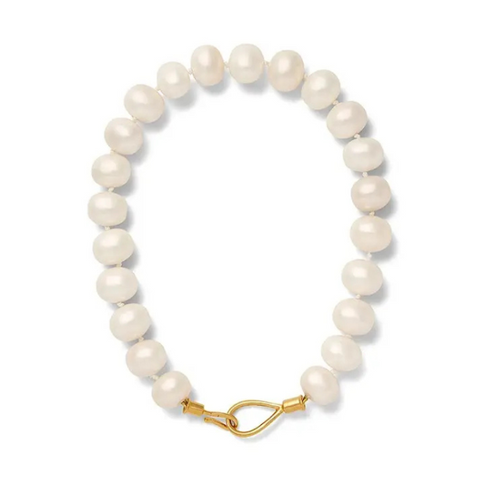 Pearl bracelet with a gold clasp on a white background