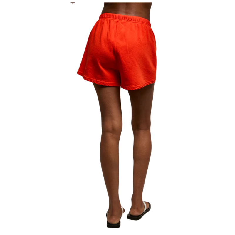 Person wearing bright red shorts on a white background