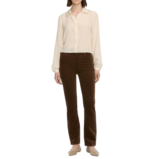 Person wearing a beige blouse and brown pants on a white background