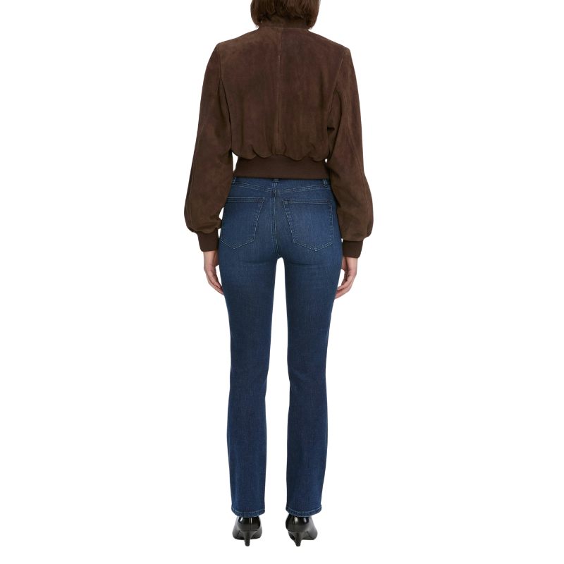 Person wearing a brown blouse and blue jeans on a white background