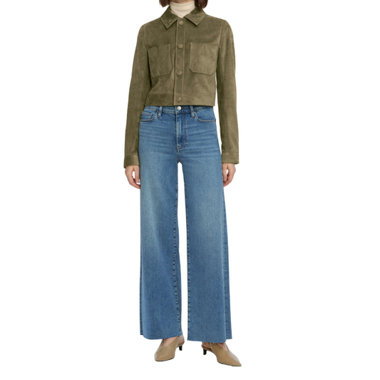 Person wearing a green jacket and blue jeans on a white background