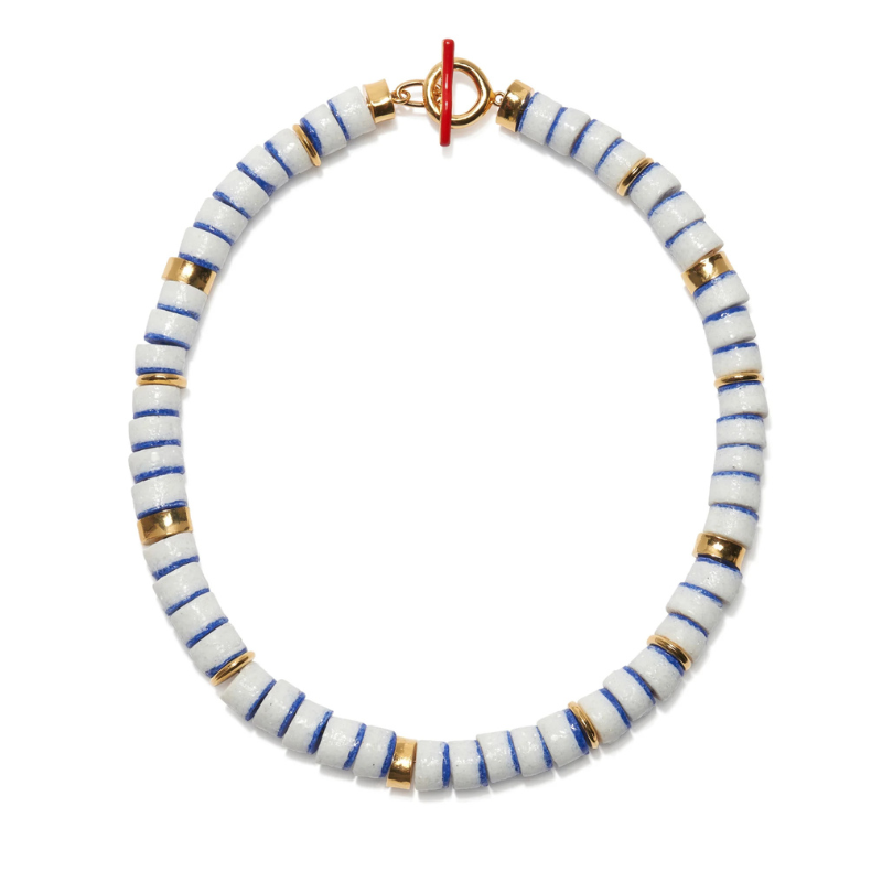 Bracelet with white beads striped with blue and gold on a white background