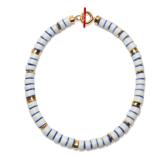 Bracelet with white beads striped with blue and gold on a white background